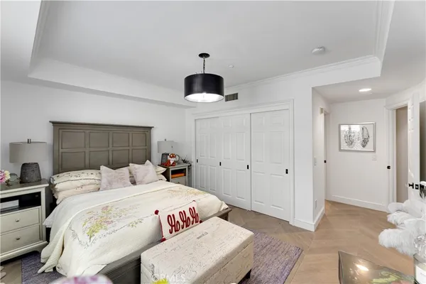 a bedroom with a bed and a chandelier