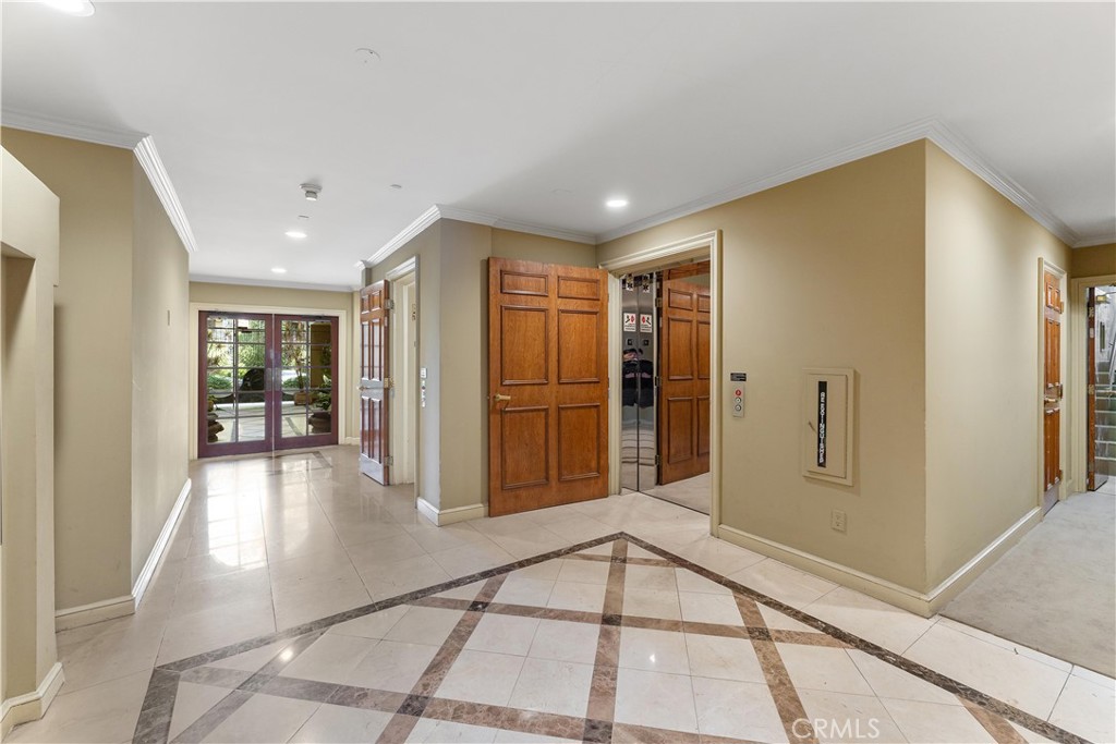 277 South Spalding Drive, Unit 201 Beverly Hills, CA 90212 - Photo 29 of 31 a view of a hallway with wooden floor and a cabinet