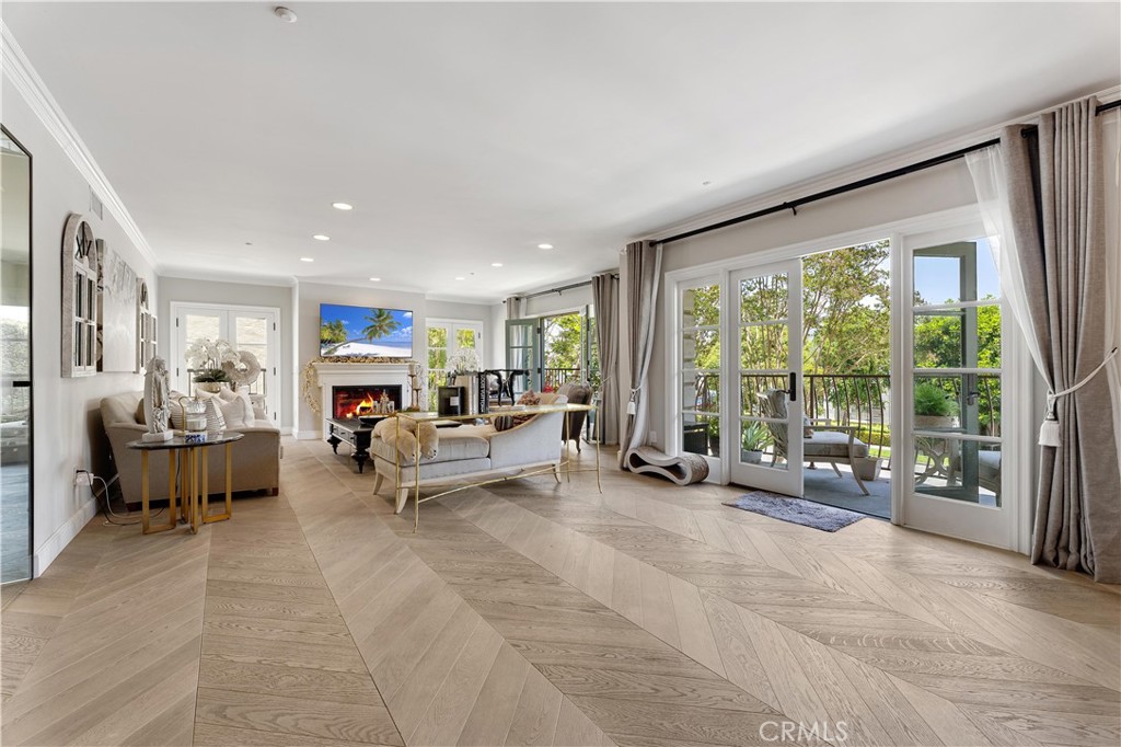 277 South Spalding Drive, Unit 201 Beverly Hills, CA 90212 - Photo 9 of 31 a living room with furniture and large windows