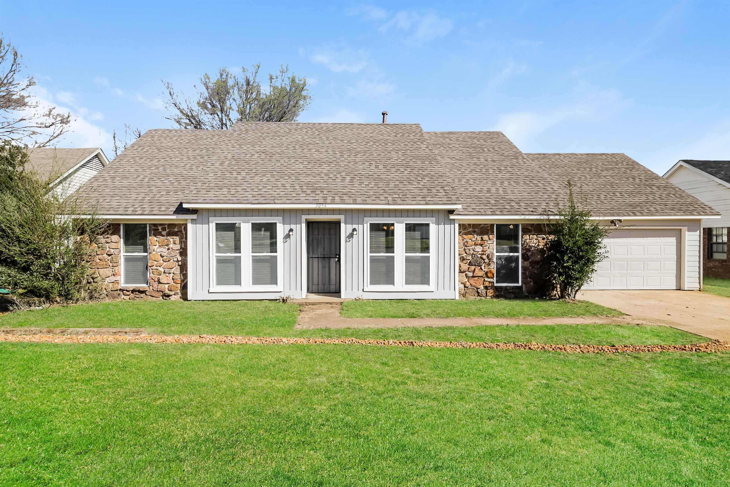 a front view of a house with a garden