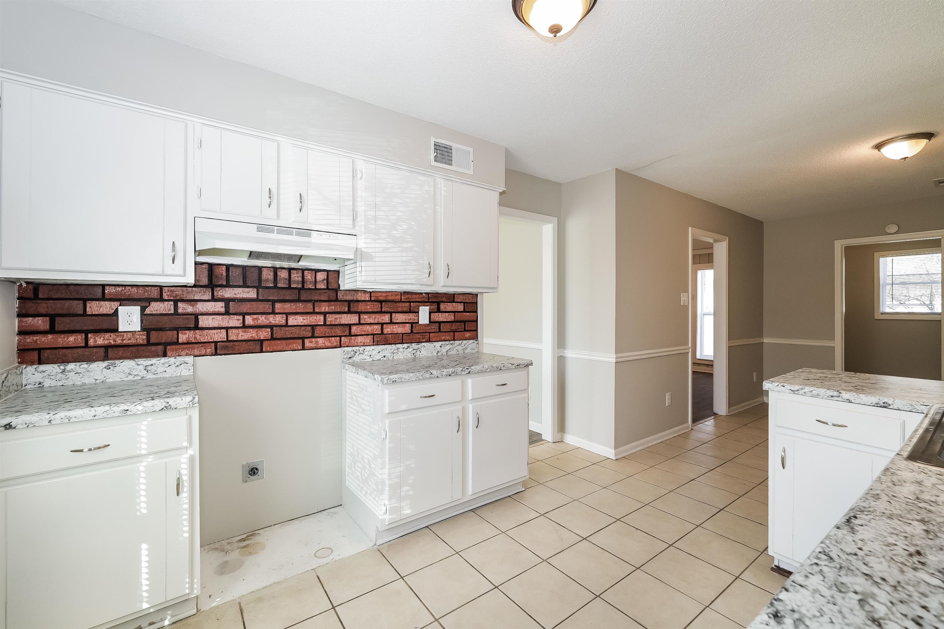 3054 Ridgeway Road Memphis, TN 38115 - Photo 7 of 17 a kitchen with white cabinets and appliances