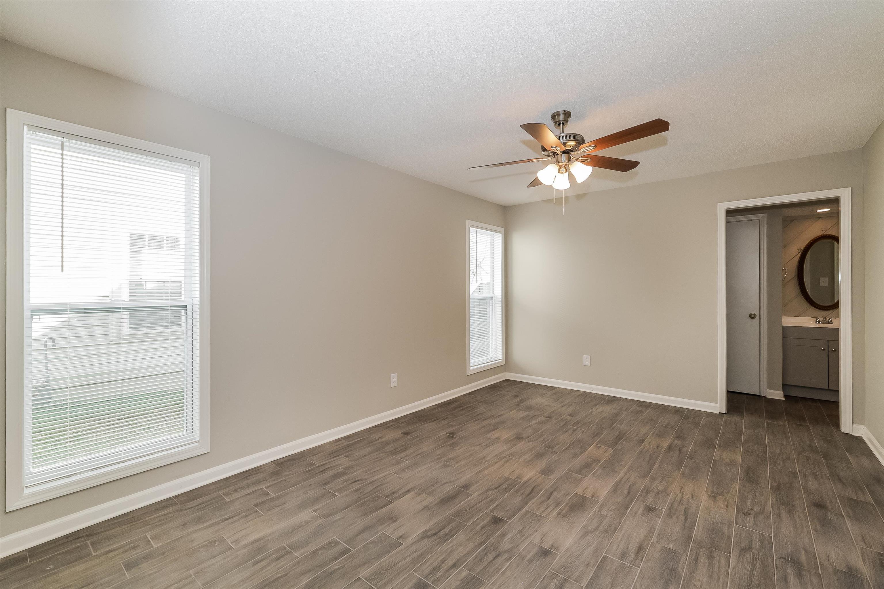 3054 Ridgeway Road Memphis, TN 38115 - Photo 10 of 17 wooden floor in an empty room with a window