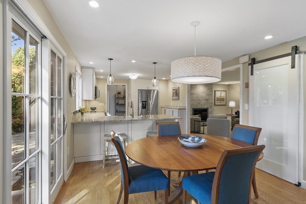 5 Crest Road Natick, MA 01760 - Photo 11 of 36 a kitchen with stainless steel appliances granite countertop a dining table chairs and white cabinets