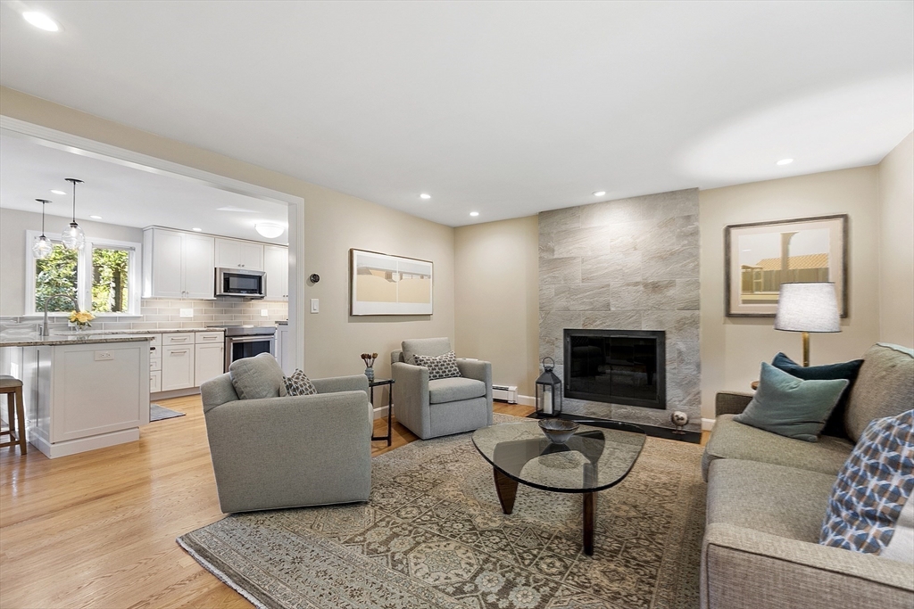 5 Crest Road Natick, MA 01760 - Photo 13 of 36 a living room with furniture a rug and a fireplace