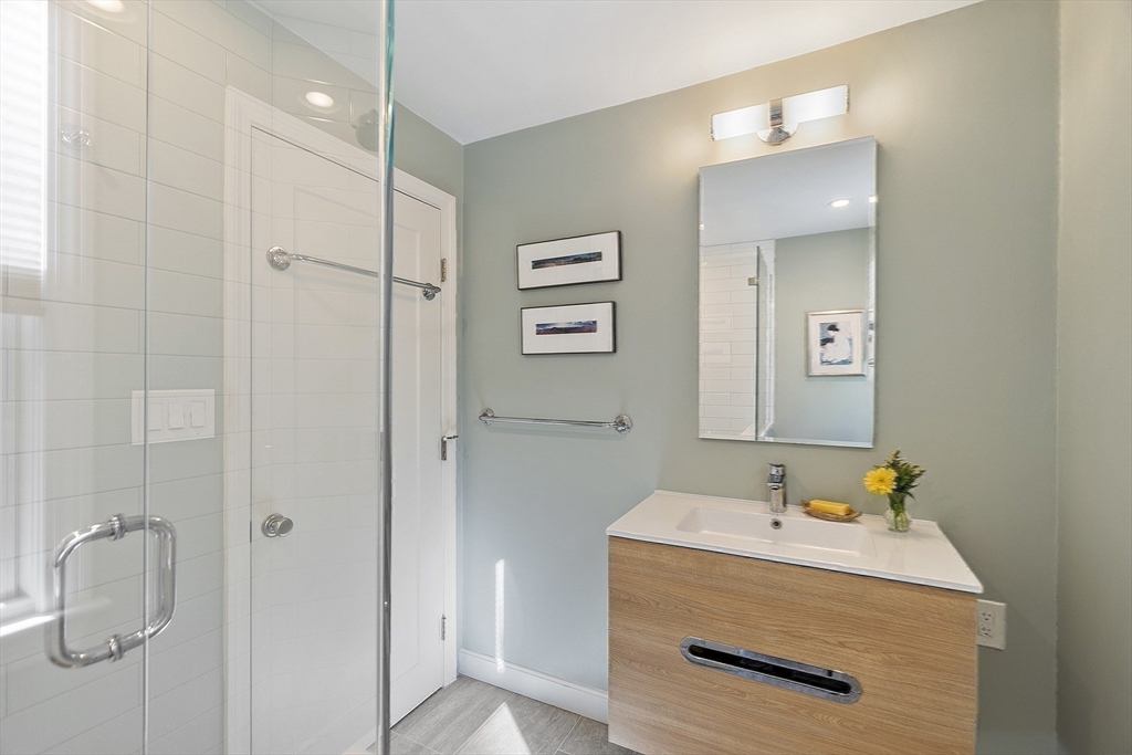 5 Crest Road Natick, MA 01760 - Photo 19 of 36 a bathroom with a sink a mirror and shower