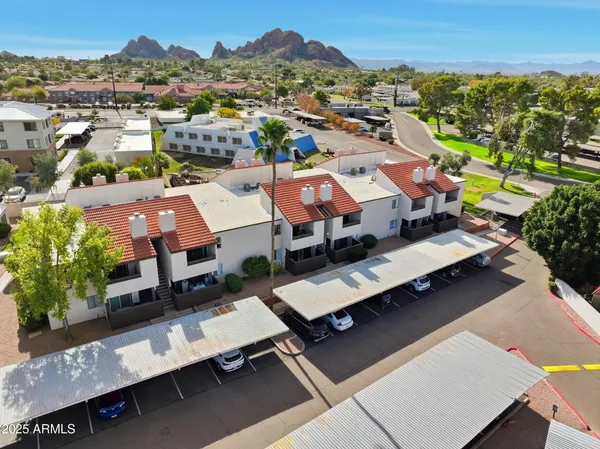 an aerial view of a houses with a city view