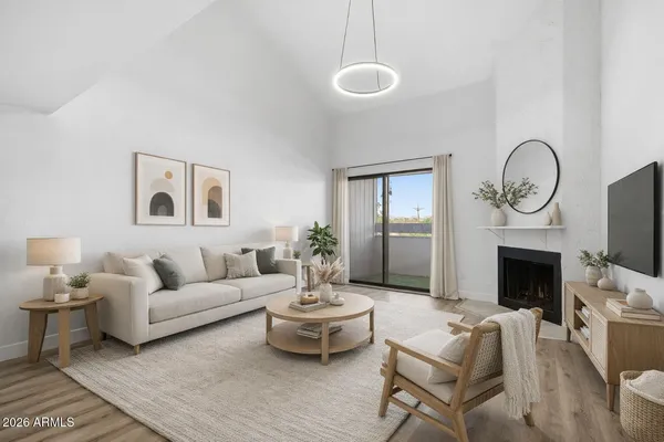 a living room with furniture a fireplace and a flat screen tv