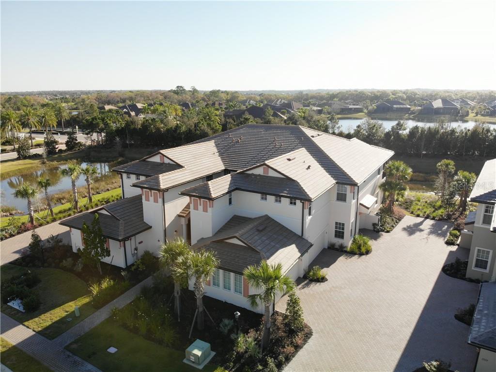 7371 Divot Loop, Unit 1404 Bradenton, FL 34202 - Photo 1 of 1 an aerial view of a house with a lake view