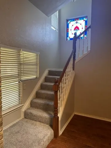 a view of entryway and hall with wooden floor