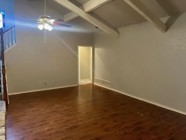 a view of wooden floor and a chandelier fan in a room