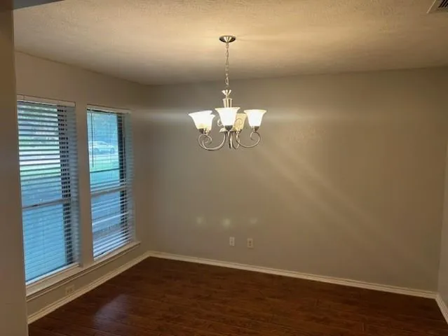 a room with a window and wooden floor
