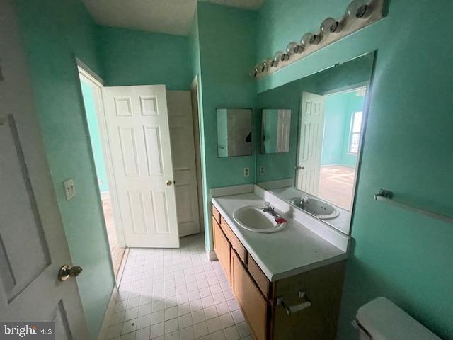 1716 Lake Shore Crest Drive, Unit 22 Reston, VA 20190 - Photo 23 of 28 a bathroom with a sink a toilet and mirror