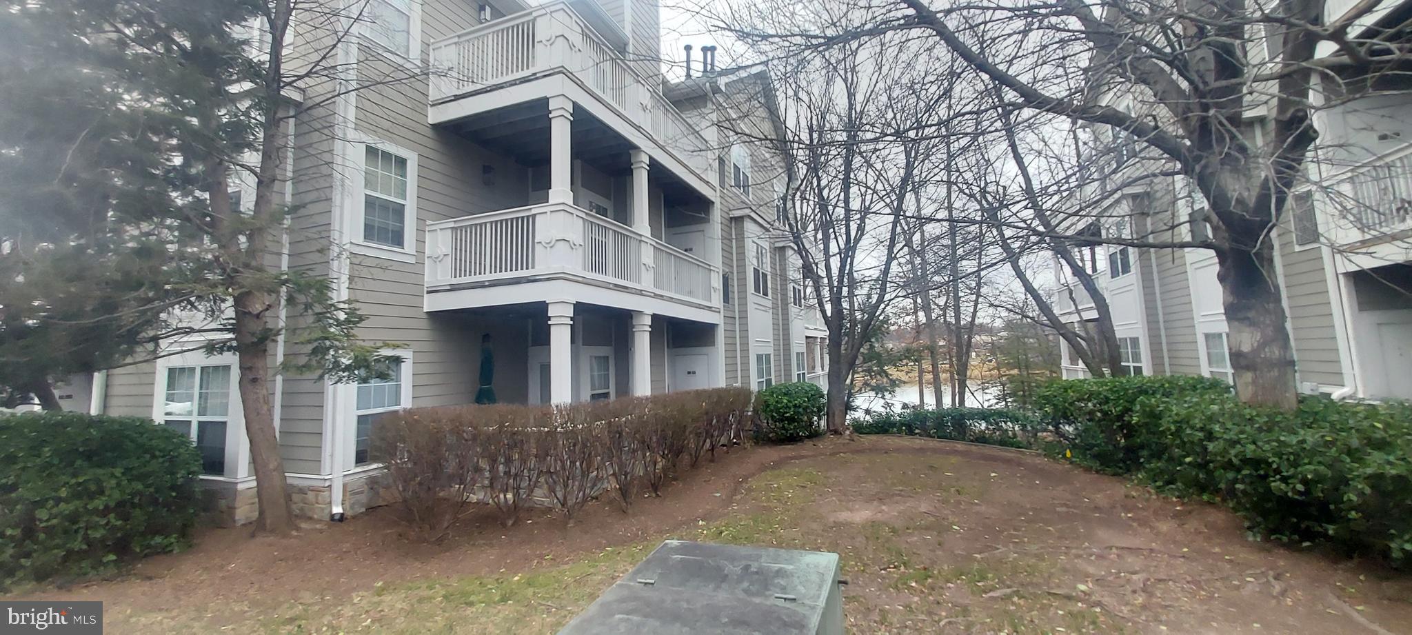 1716 Lake Shore Crest Drive, Unit 22 Reston, VA 20190 - Photo 3 of 28 a front view of a house with a yard