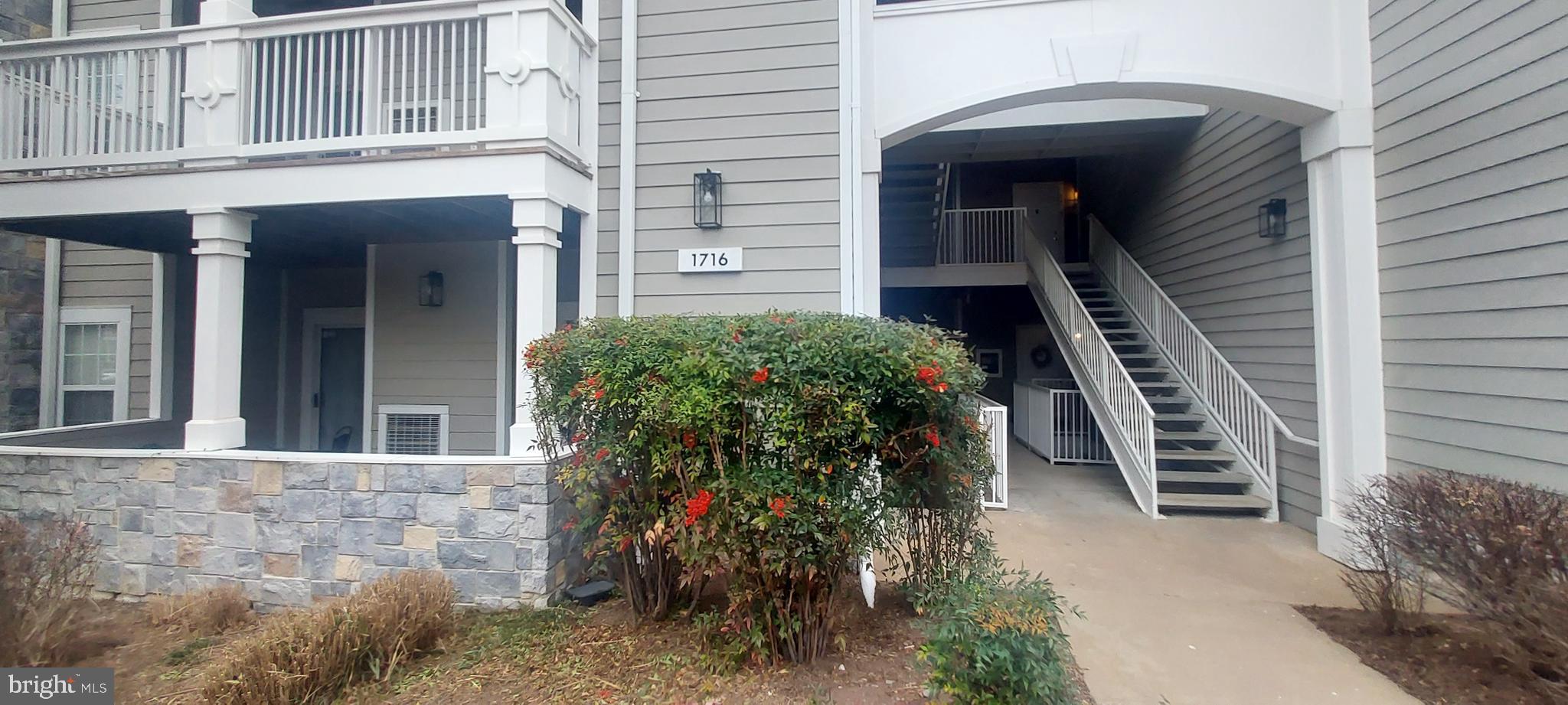 1716 Lake Shore Crest Drive, Unit 22 Reston, VA 20190 - Photo 4 of 28 a front view of a house with a yard