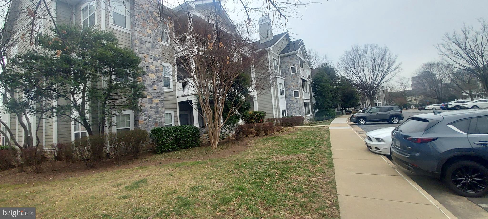 1716 Lake Shore Crest Drive, Unit 22 Reston, VA 20190 - Photo 5 of 28 a view of a yard with cars