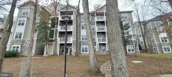 a view of a house with a door and covered trees