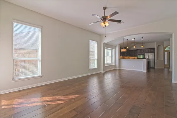 a kitchen with center island with wooden floor and cabinets