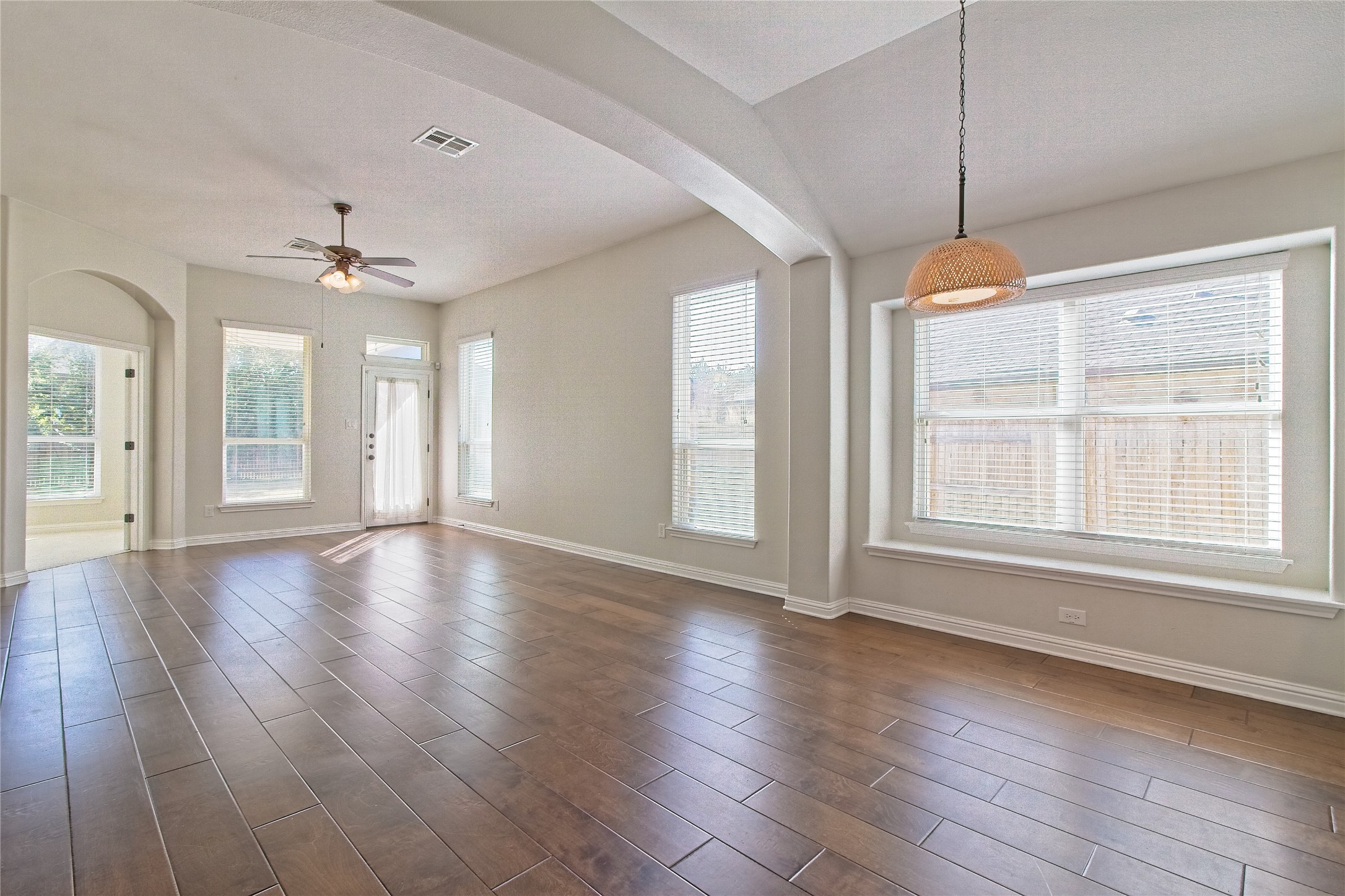 3618 Penelope Way Round Rock, TX 78665 - Photo 14 of 36 an empty room with wooden floor chandelier and windows