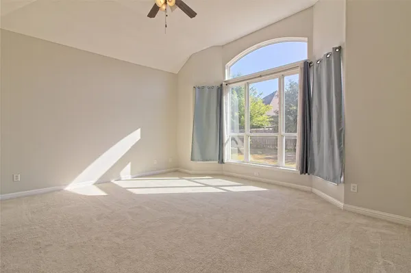 an empty room with windows and closet