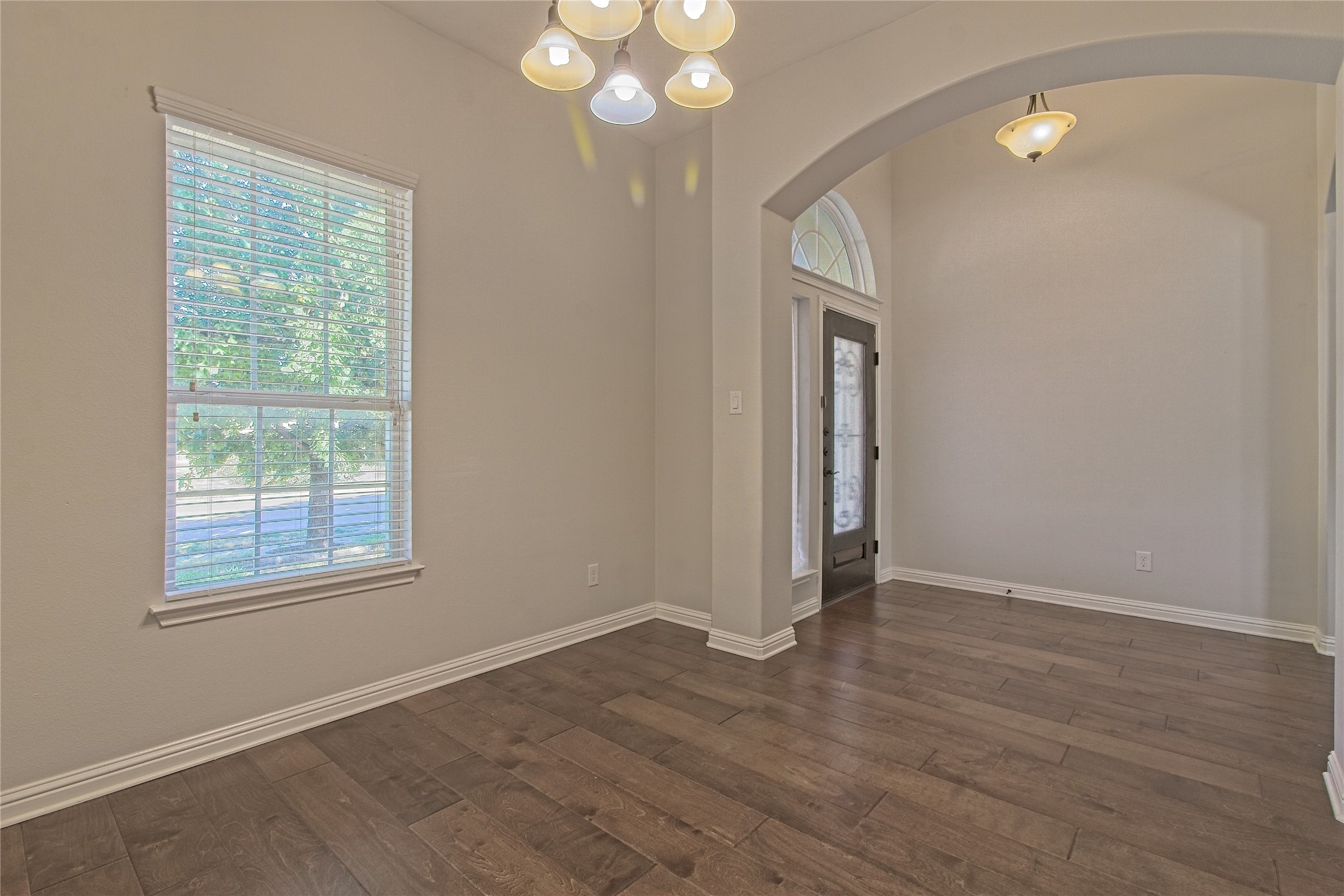 3618 Penelope Way Round Rock, TX 78665 - Photo 6 of 36 a view of an empty room with wooden floor and a window