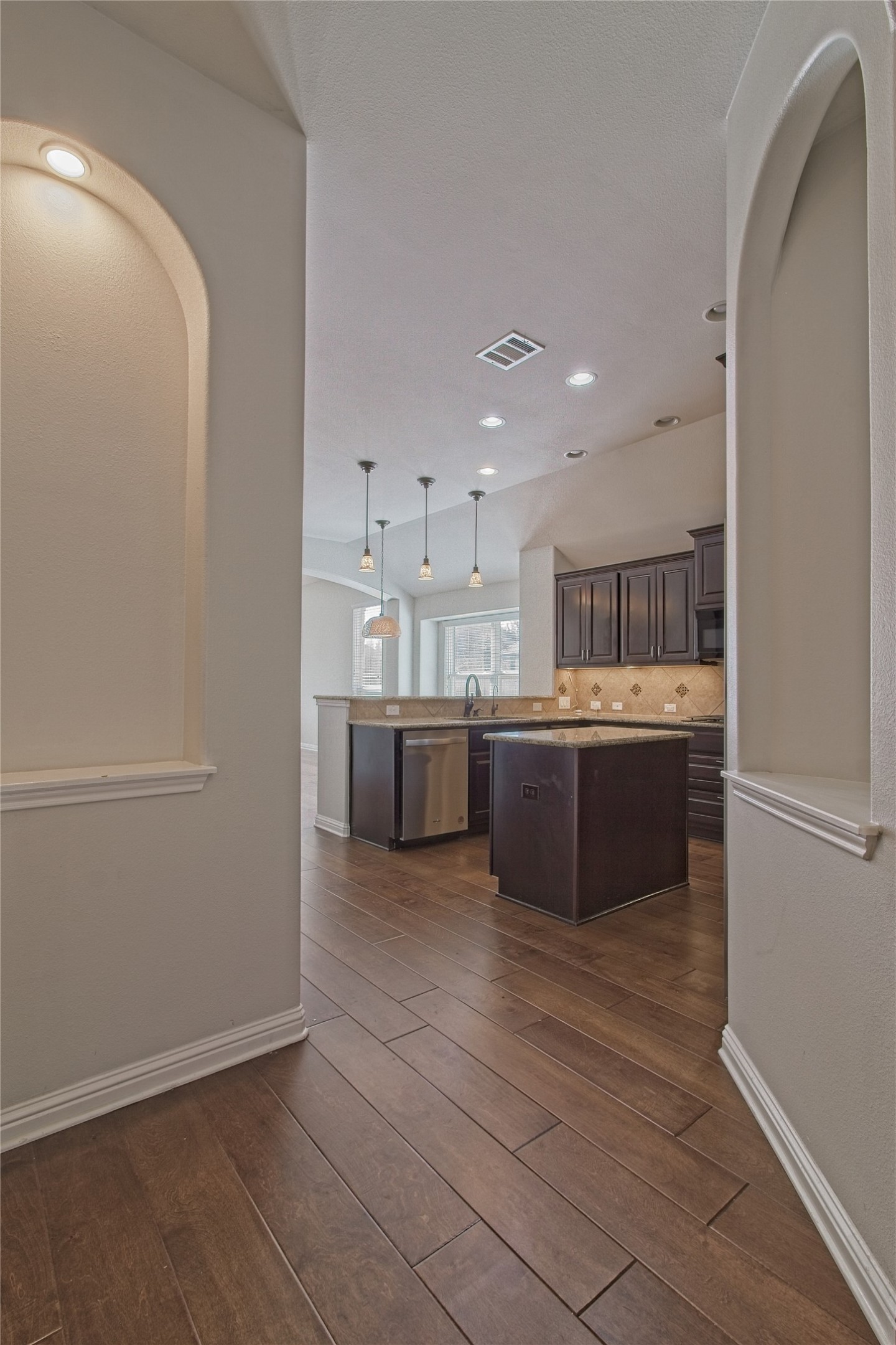 3618 Penelope Way Round Rock, TX 78665 - Photo 7 of 36 a large white kitchen with a sink and dishwasher a refrigerator with wooden floor