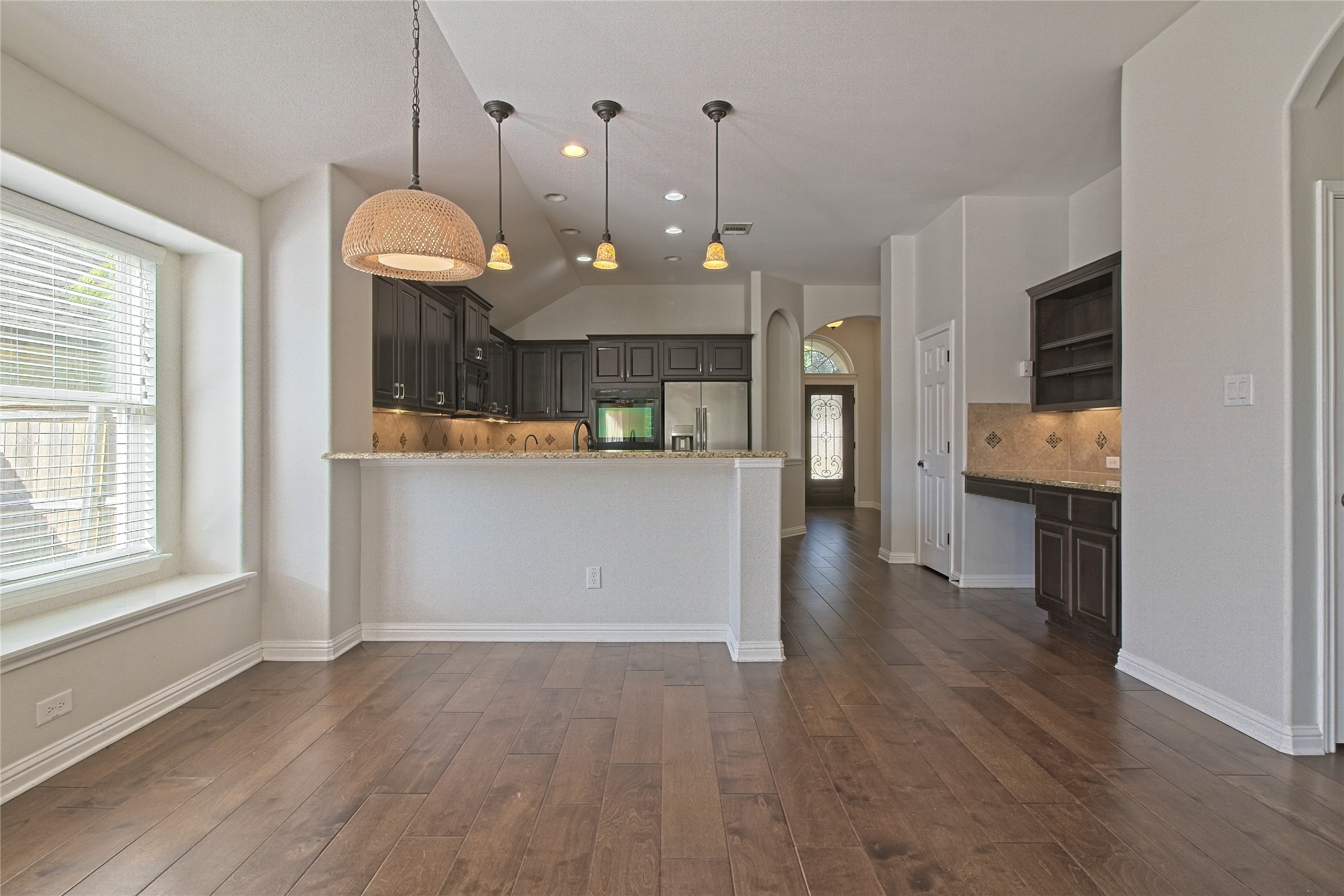 3618 Penelope Way Round Rock, TX 78665 - Photo 8 of 36 wooden floor in an empty room with a kitchen