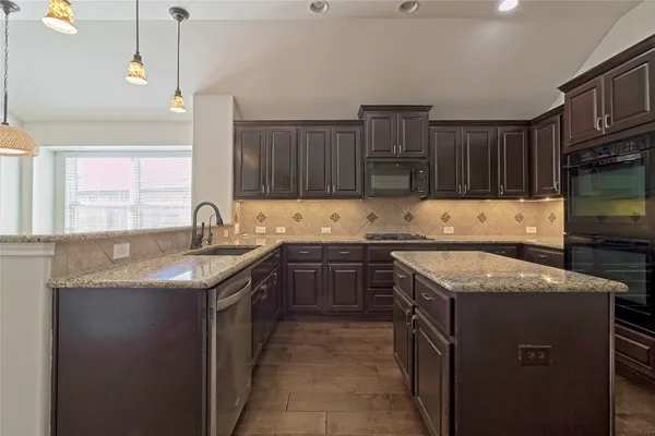 wooden floor in an empty room with a kitchen