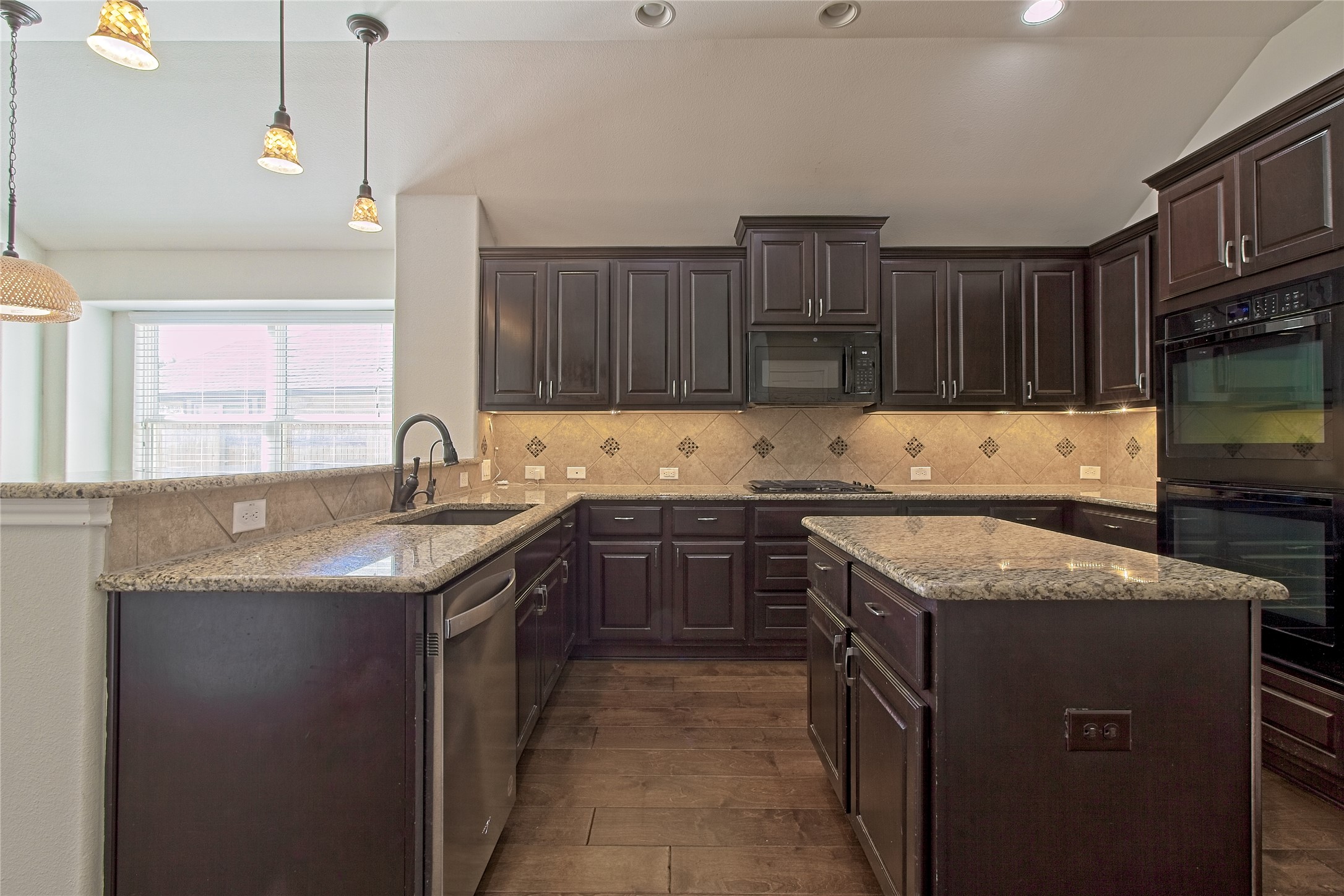 3618 Penelope Way Round Rock, TX 78665 - Photo 9 of 36 a kitchen with granite countertop a sink stove and cabinets