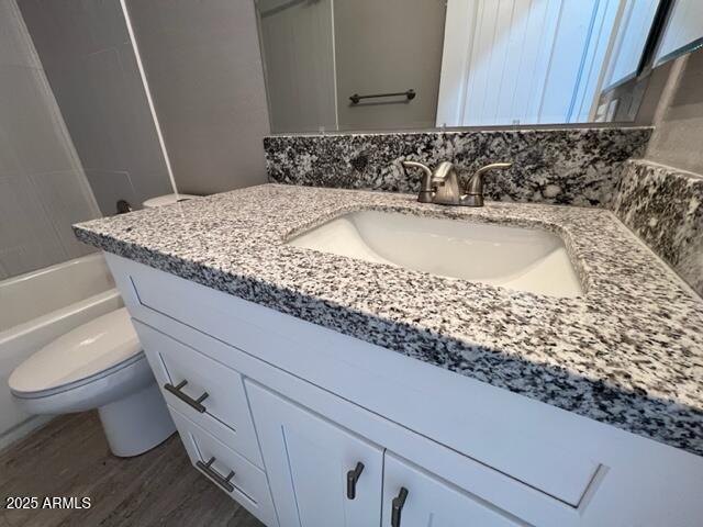 4552 North Loring Road Casa Grande, AZ 85194 - Photo 19 of 48 a bathroom with a granite countertop sink a toilet and bathtub