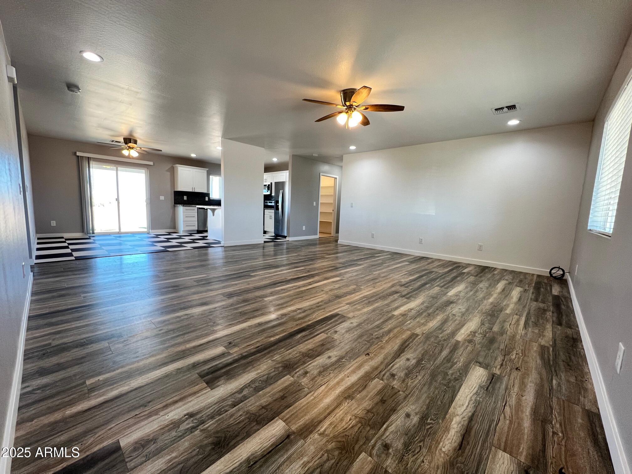 4552 North Loring Road Casa Grande, AZ 85194 - Photo 2 of 48 wooden floor in an empty room with a window