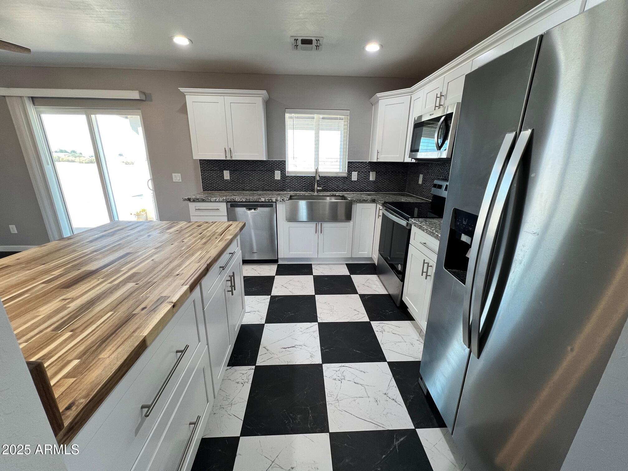 4552 North Loring Road Casa Grande, AZ 85194 - Photo 5 of 48 a kitchen with a refrigerator a sink and a vanity