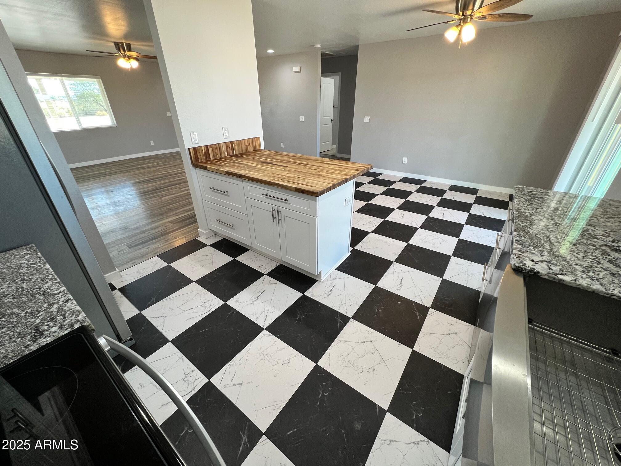 4552 North Loring Road Casa Grande, AZ 85194 - Photo 6 of 48 a living room with a checkered floor