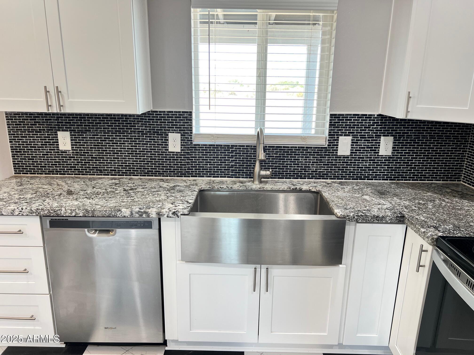 4552 North Loring Road Casa Grande, AZ 85194 - Photo 8 of 48 a kitchen with granite countertop a sink and a stove
