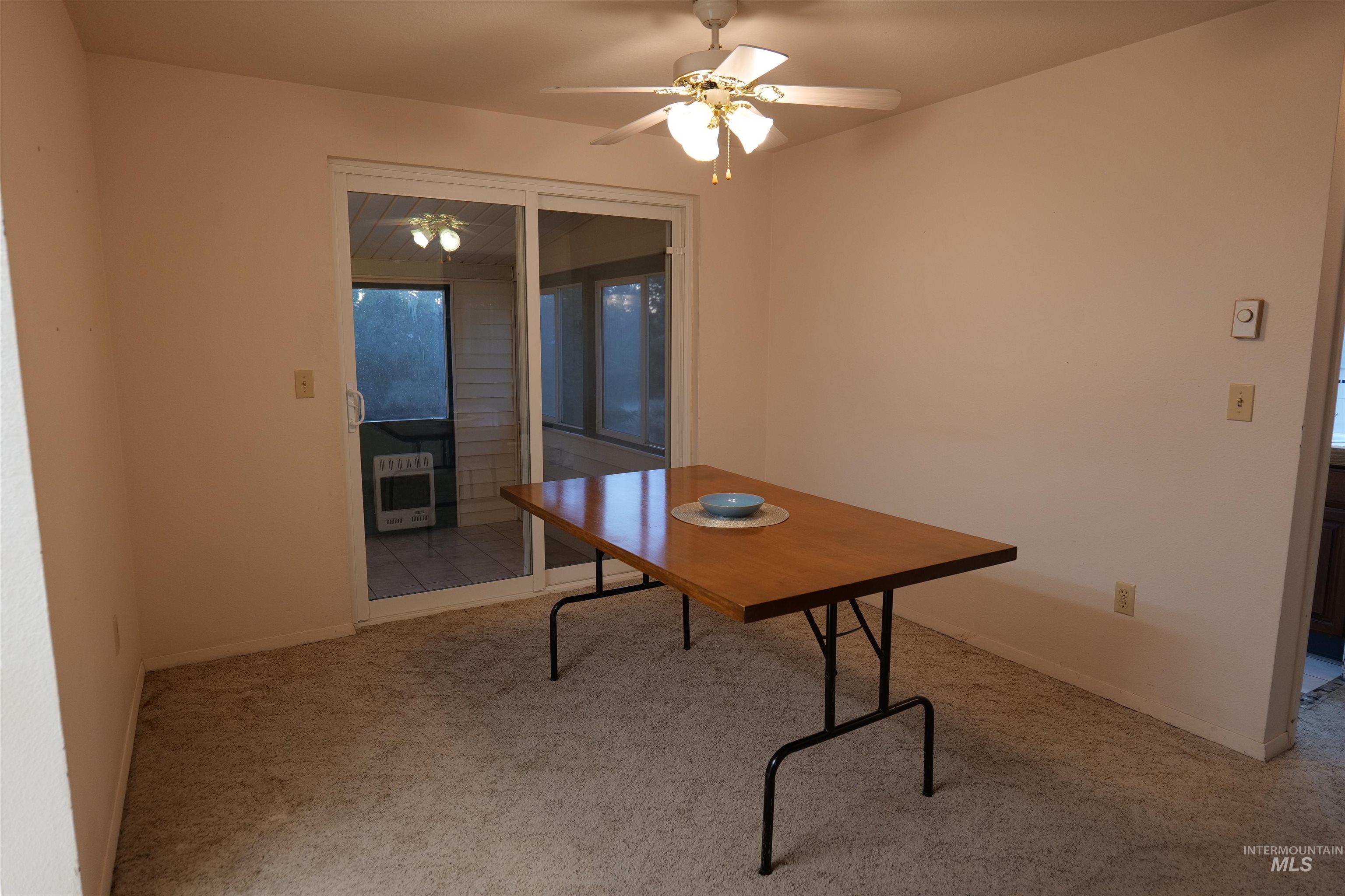 1485 East 9th Street Weiser, ID 83672 - Photo 3 of 18 Interior room featuring neutral-toned walls, light-colored carpet, and a ceiling fan with integrated lighting