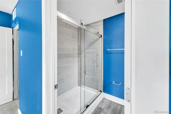 a bathroom with a glass shower door