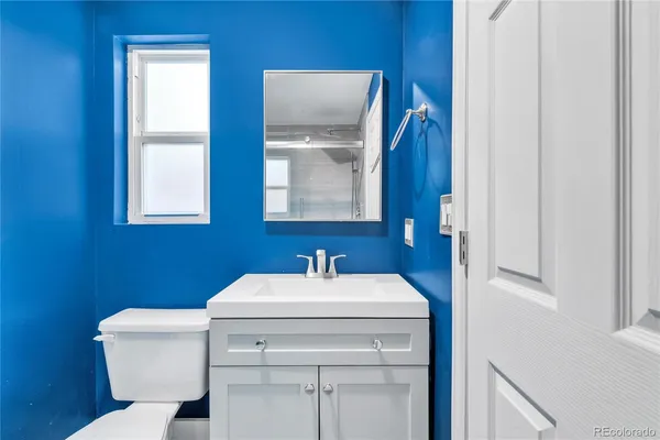 a bathroom with a sink toilet and mirror