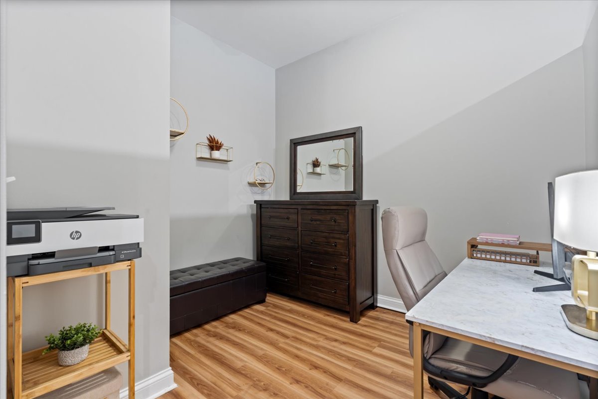 2025 South Indiana Avenue, Unit 407 Chicago, IL 60616 - Photo 13 of 17 a bedroom with a bed and a desk