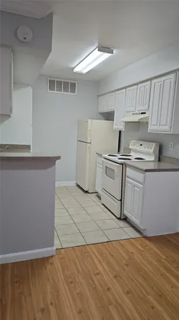a kitchen with a sink a stove and cabinets