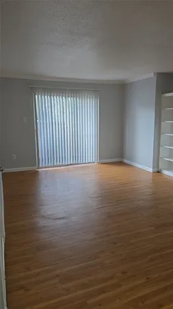 a view of a room with wooden floor
