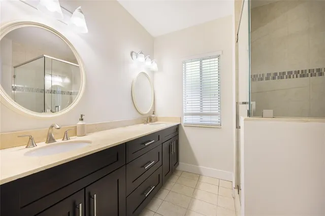 a bathroom with a double vanity sink and a mirror