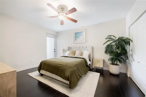 a bedroom with a bed and a potted plant