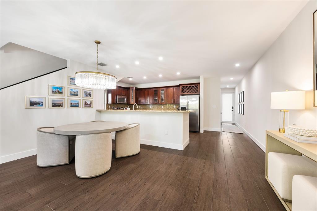 834 Southwest 16th Street Fort Lauderdale, FL 33315 - Photo 9 of 26 a kitchen with stainless steel appliances a sink a stove a refrigerator and island with wooden floor