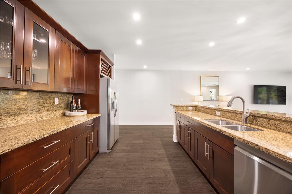 834 Southwest 16th Street Fort Lauderdale, FL 33315 - Photo 10 of 26 a kitchen with stainless steel appliances granite countertop a sink stove and cabinets