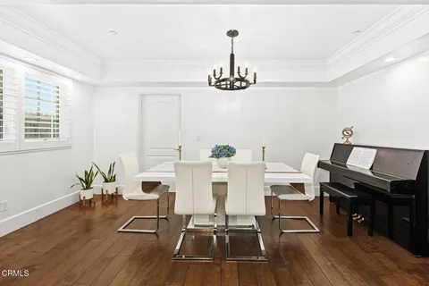 a view of a workspace with furniture and wooden floor