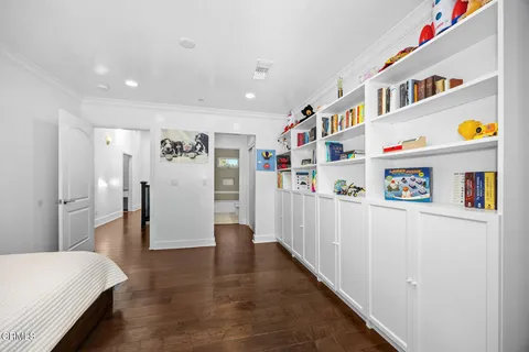 a view of hallway with wooden floor and furniture