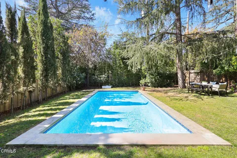 a view of a backyard with swimming pool