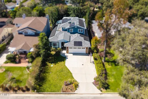 an aerial view of a house with a yard basket ball court and outdoor seating