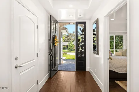 a view of hallway with wooden floor and garden