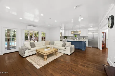 a living room with furniture and kitchen view