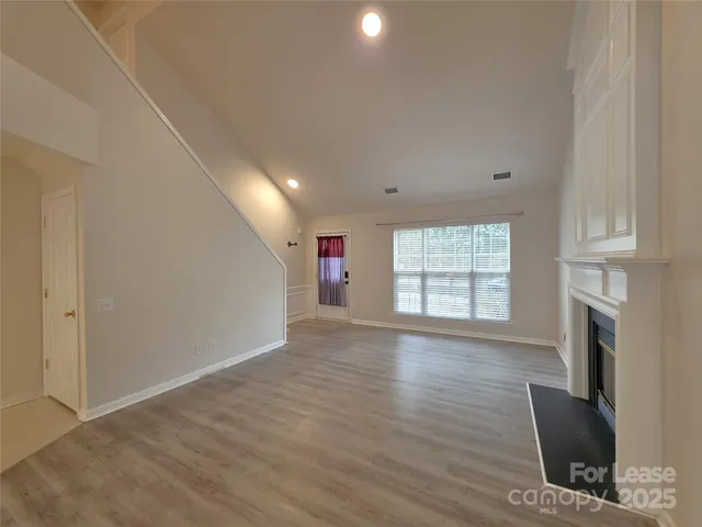 a view of livingroom with hardwood floor and a fireplace